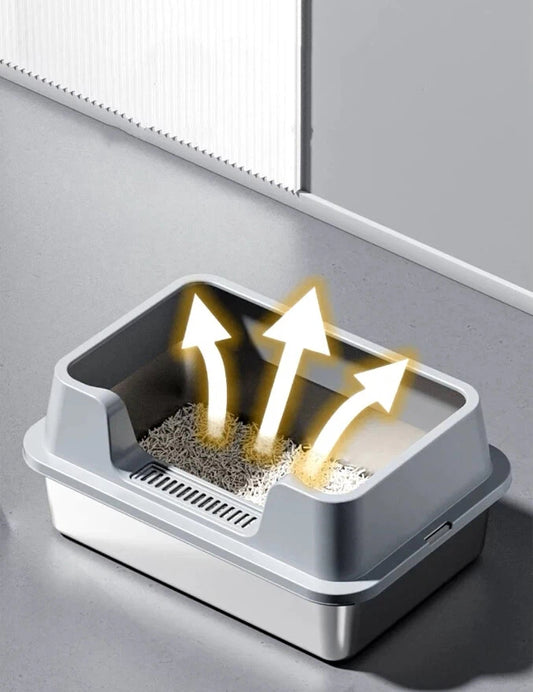 Gray plastic cat litter box with litter and arrows indicating odor ventilation in a clean indoor space