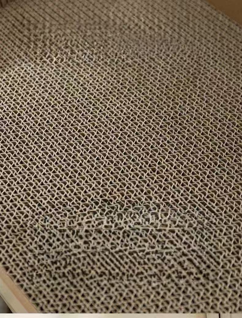 Close-up of a textured beige corrugated cardboard surface with a honeycomb pattern - OKIEEPET