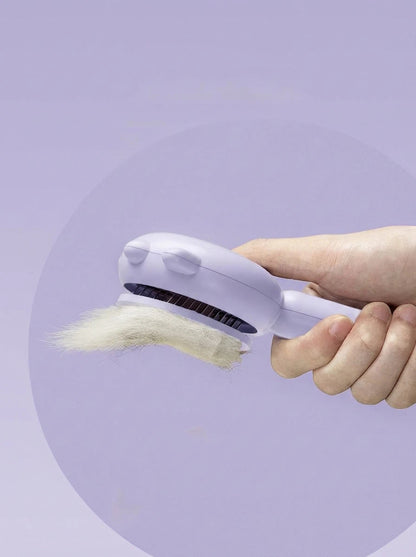 Hand holding purple fabric shaver with removed white lint against pastel purple background