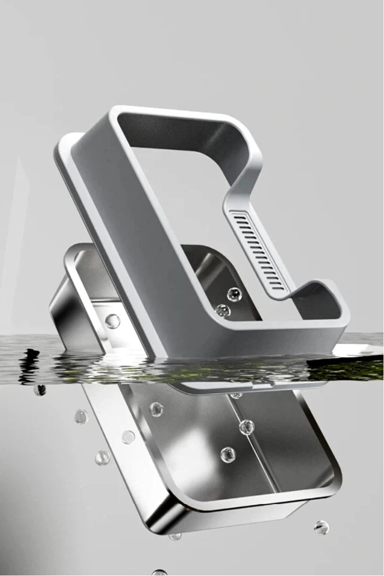 Silver metal juicer partially submerged in water with water droplets around