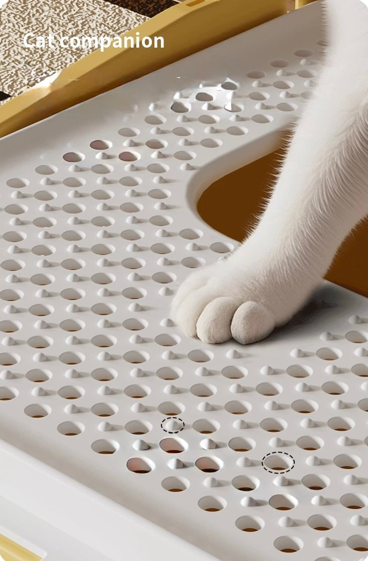 White cat paw stepping on perforated white plastic surface with yellow edges, pet accessory