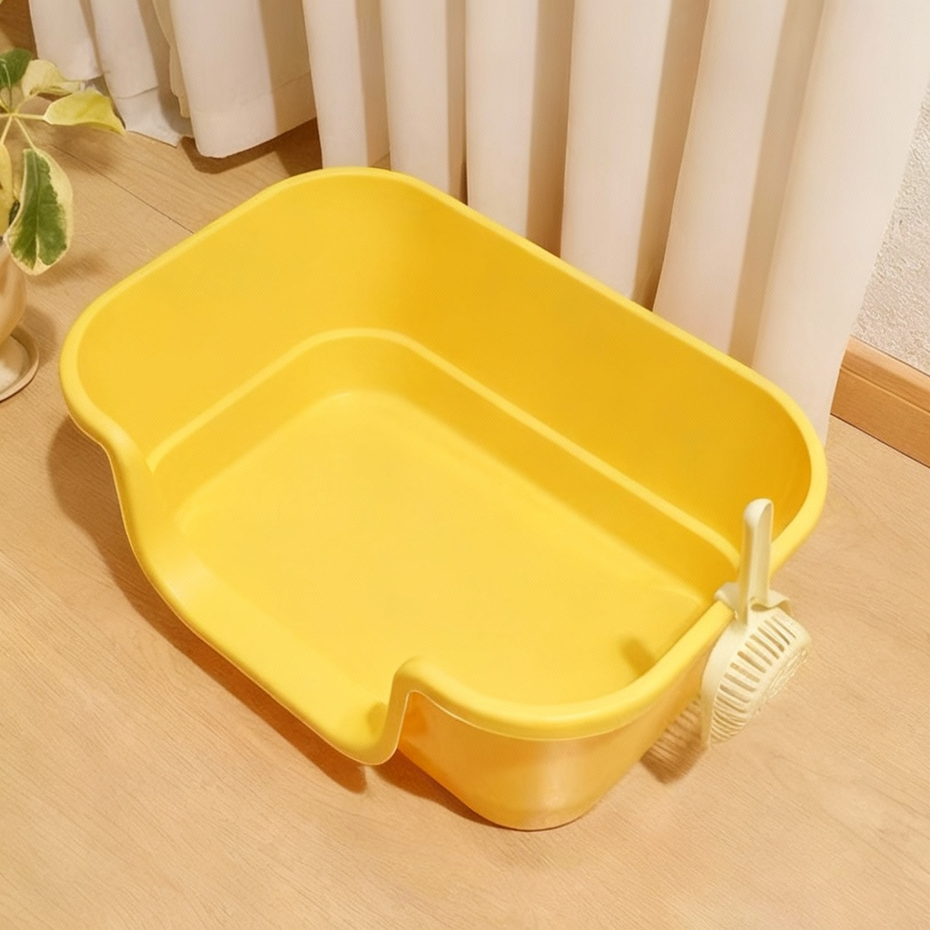 Yellow plastic wash basin with a drain strainer on wooden floor near cream curtains and a potted plant