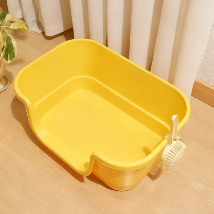 Yellow plastic wash basin with a drain strainer on wooden floor near cream curtains and a potted plant