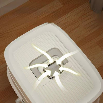 Top view of white air purifier on wooden floor with arrows showing air intake