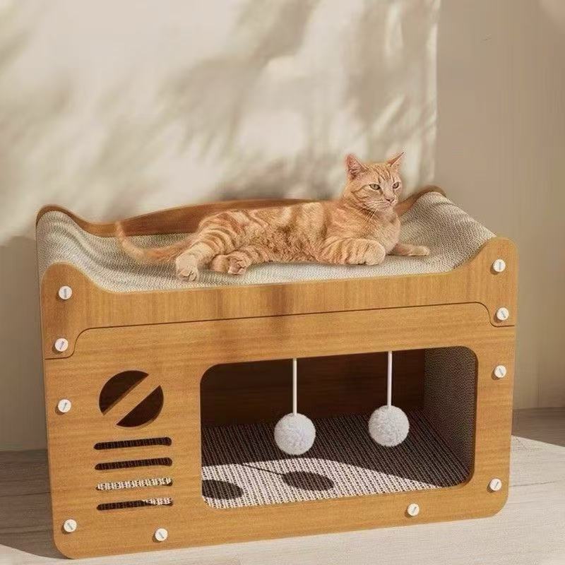 Orange tabby cat lounging on modern wooden cat bed with hanging pom-pom toys