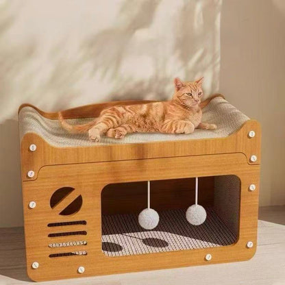 Orange tabby cat lounging on modern wooden cat bed with hanging pom-pom toys