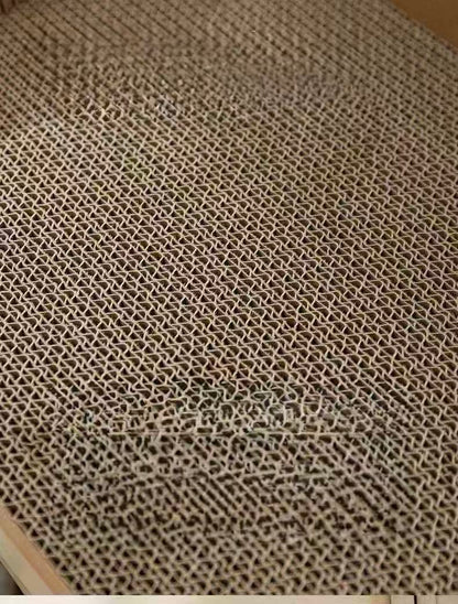 Close-up of a textured beige corrugated cardboard surface with a honeycomb pattern