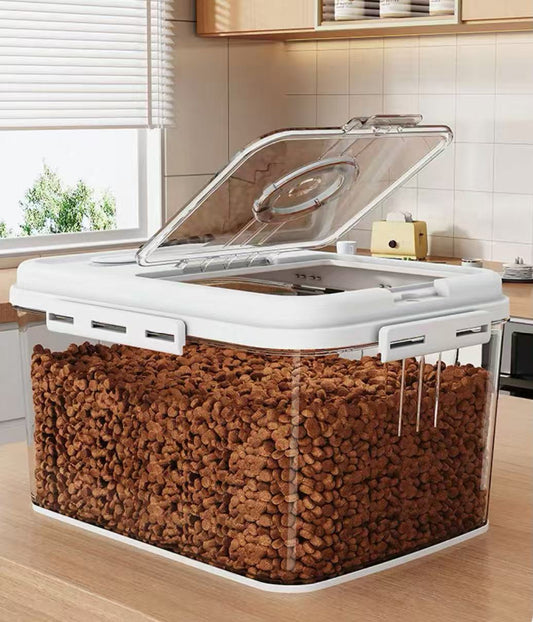 Clear plastic airtight pet food storage container filled with brown kibble on kitchen counter