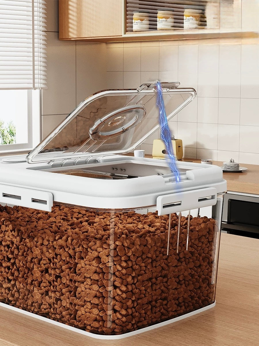 Transparent kitchen storage container with open lid storing brown pet food kibble on wooden countertop