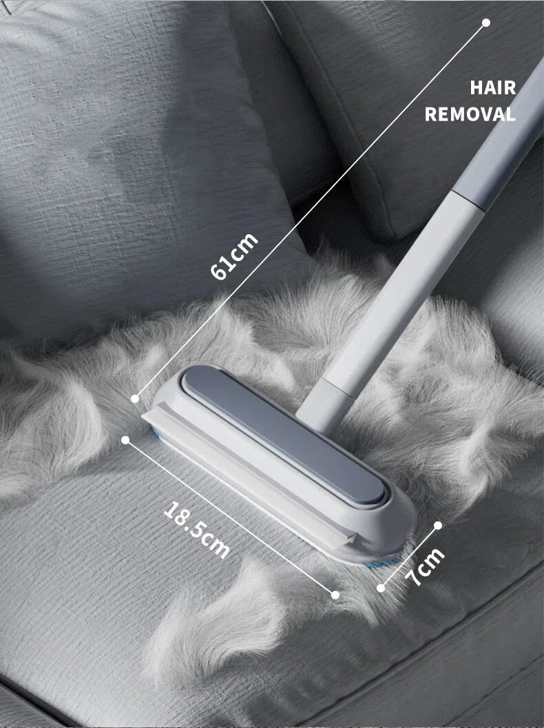 Pet hair remover brush with 61cm handle on gray fabric with white pet fur