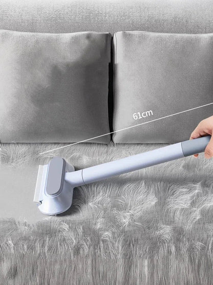 Hand using 61cm lint remover brush on grey fluffy fabric next to two grey cushions